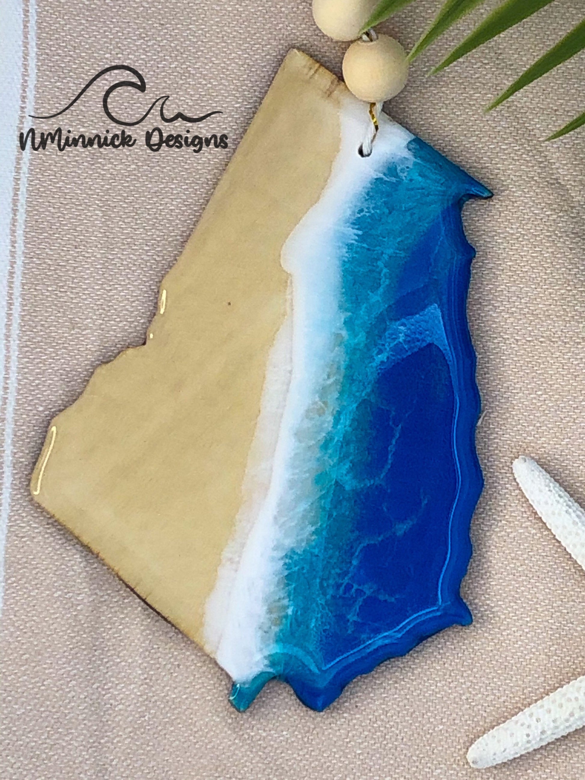 4.5 to 5 inch laser cut wood ornament in the shape of Georgia. Coastal ocean scene created with epoxy resin and blue, teal, and white mica pigments.