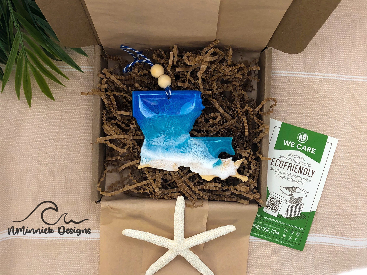 Louisiana ocean resin ornament packaged in ecofriendly plastic free materials with recyclable box, tissue paper and paper shred.