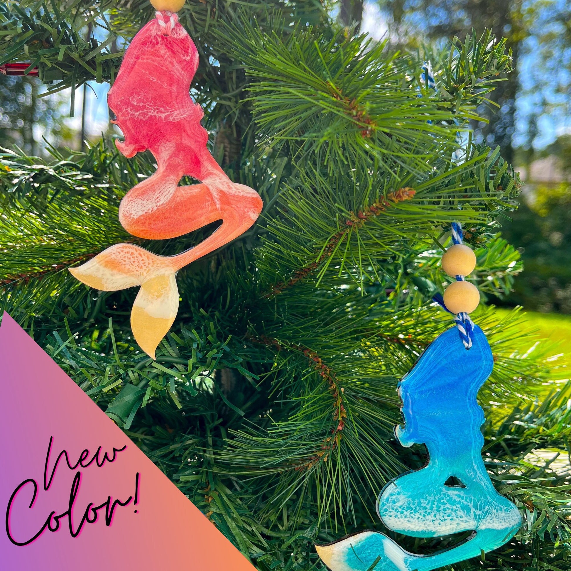 Mermaid shaped wooden ornament covered in ocean resin art, resembling the waves of the ocean. Available in Ocean Blue and Sunrise Pink. Finished with baker&#39;s twine and two wooden beads and hanging from a christmas tree.