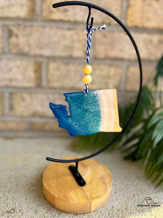 Washington ornament with ocean resin art hanging from an ornament stand.