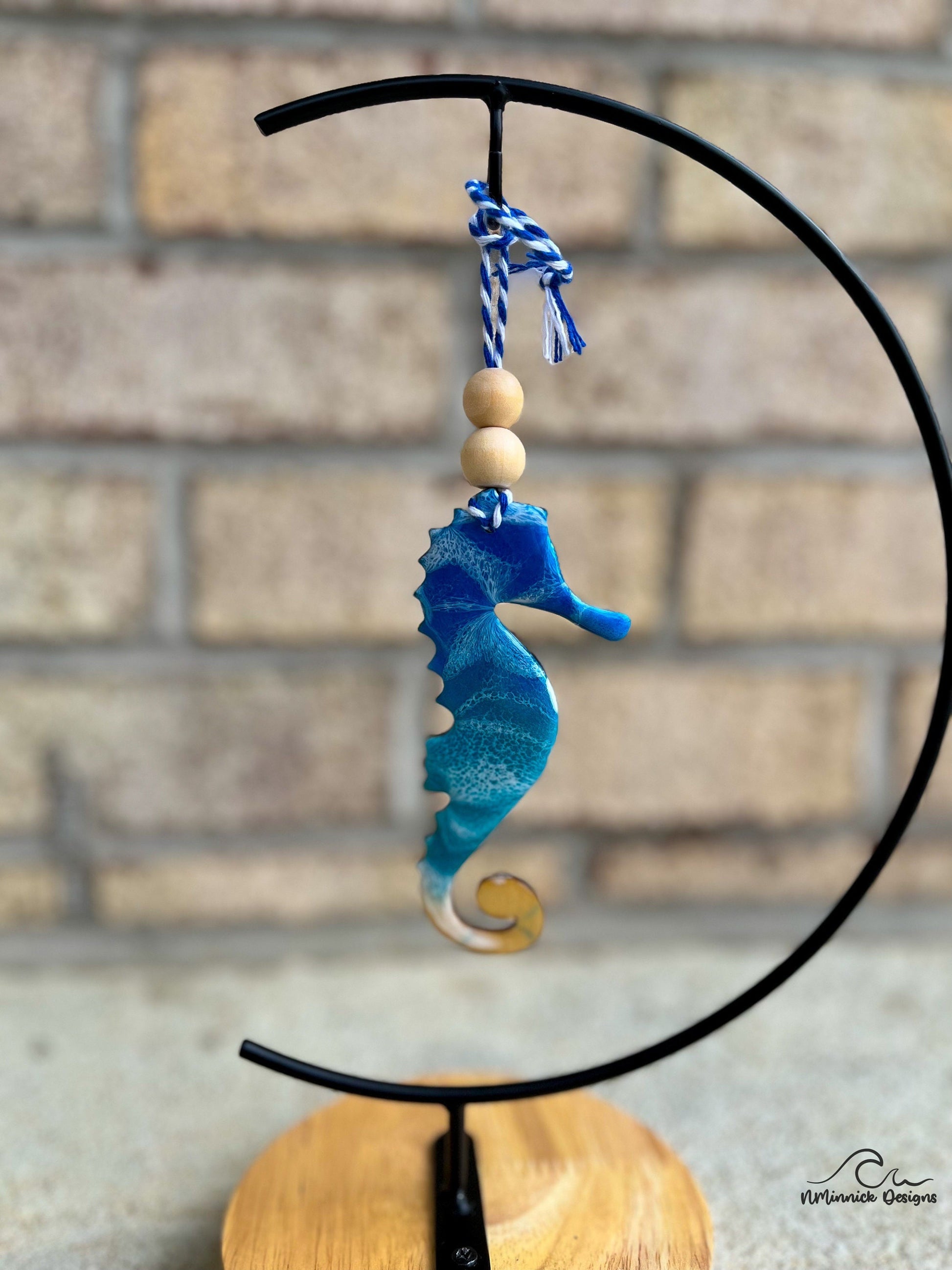 Seahorse Ornament with Ocean Resin Art hanging on an ornament stand.