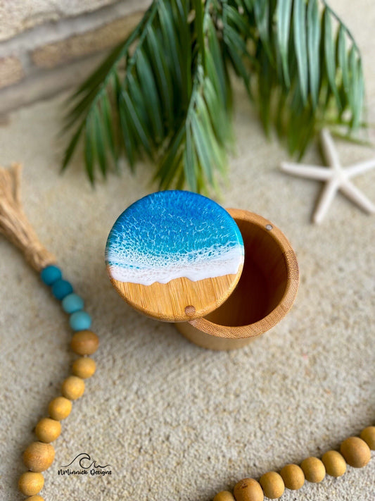 Small bamboo salt cellar with ocean blue and okinawa blue ocean resin art on top with a magnetic closure.