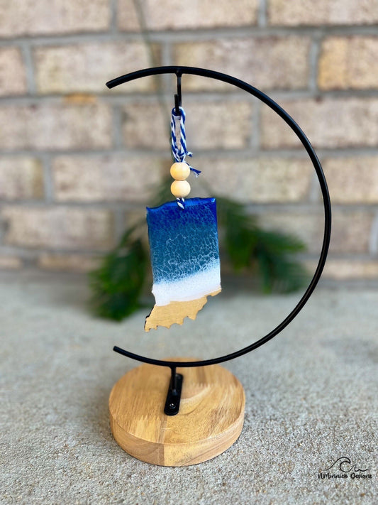 Indiana shaped wooden ornament adorned with dark blue and grey blue resin waves inspired by the great lakes