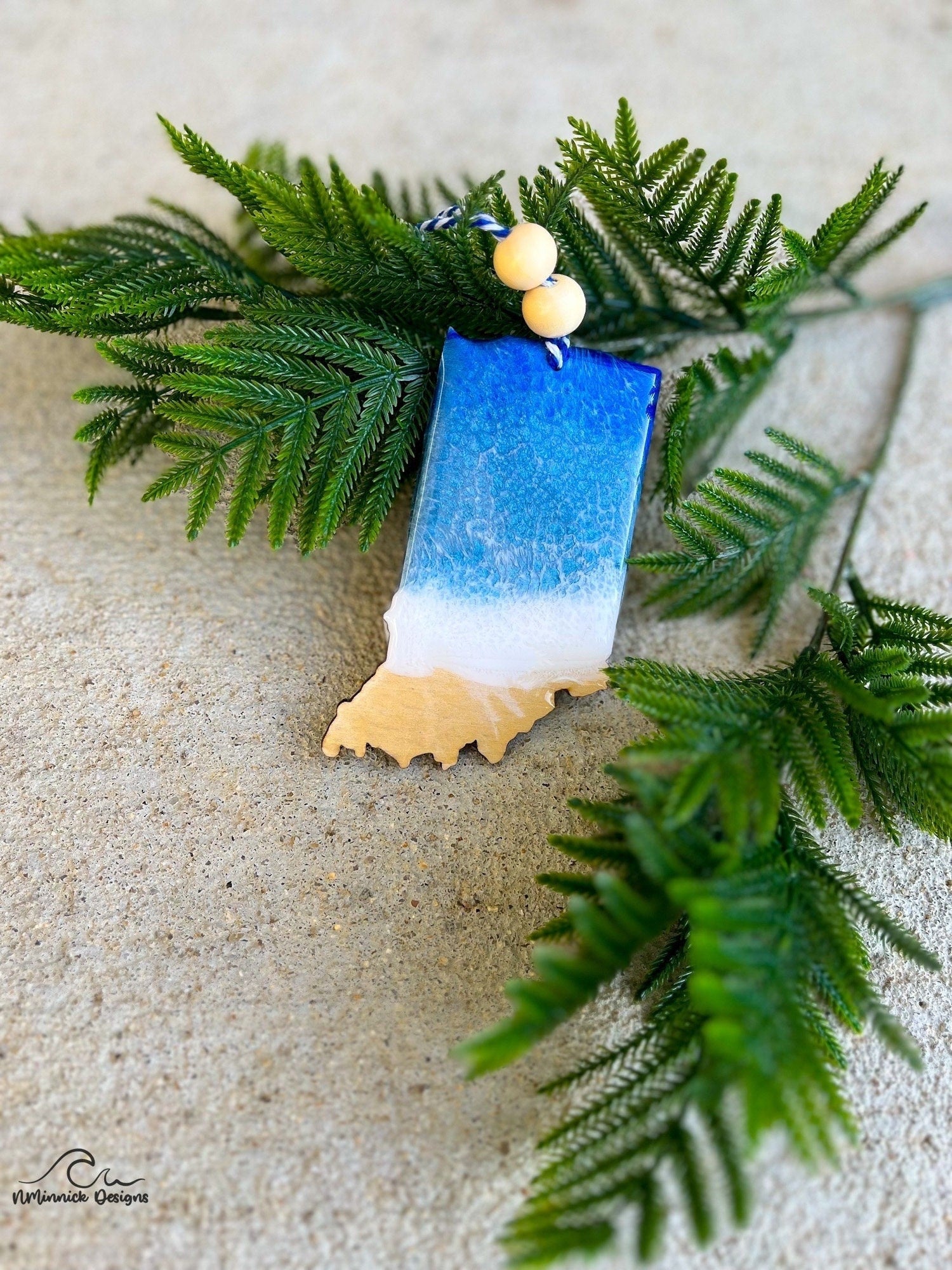 Indiana shaped wooden ornament adorned with dark blue and grey blue resin waves inspired by the great lakes