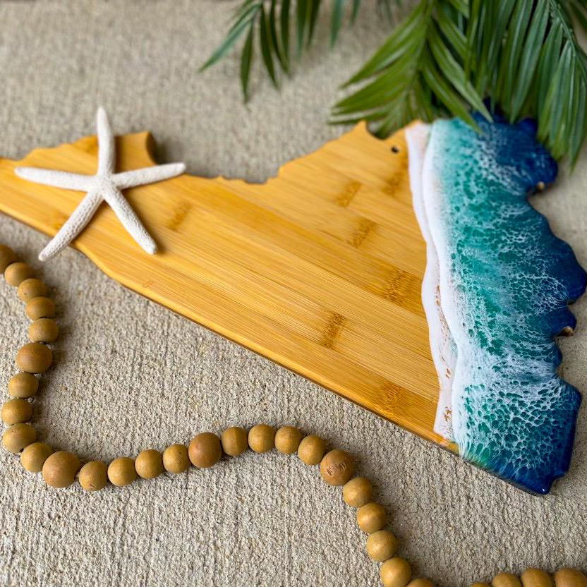 Bamboo Virginia State shaped charcuterie board with dark blue and teal ocean resin waves on the coastal side of the board.