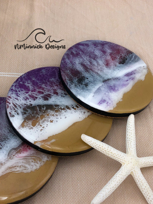 Set of 4 ocean resin coasters with a purple, red, and black ocean scene made of epoxy resin. cork backing.