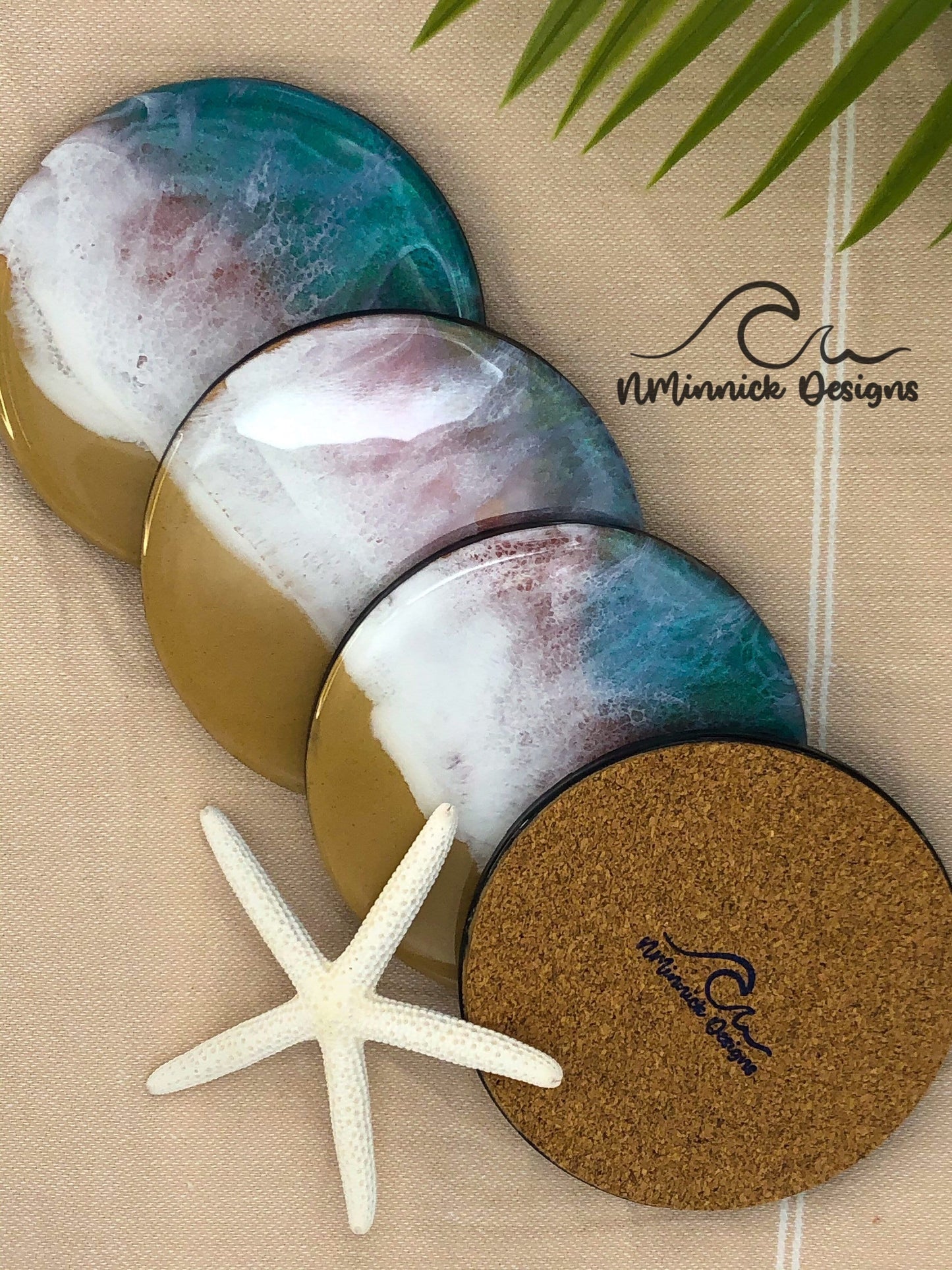 emerald and pink ocean resin coasters set of 4 with cork backings. Real sand used for the beach portion of the coaster. Resin and colored mica used to create the ocean wave pattern unique to each item.