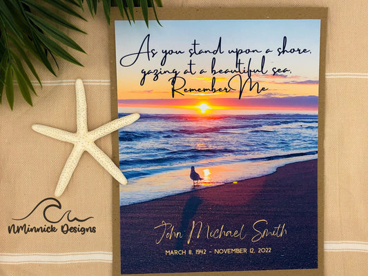 Photo of a sunrise on beach with a seagull. 8x10 memorial print with a customizable name and birth and death dates at the bottom against the sand and a poem on top that reads As you stand upon a shore, gazing at a beautiful sea, remember me.