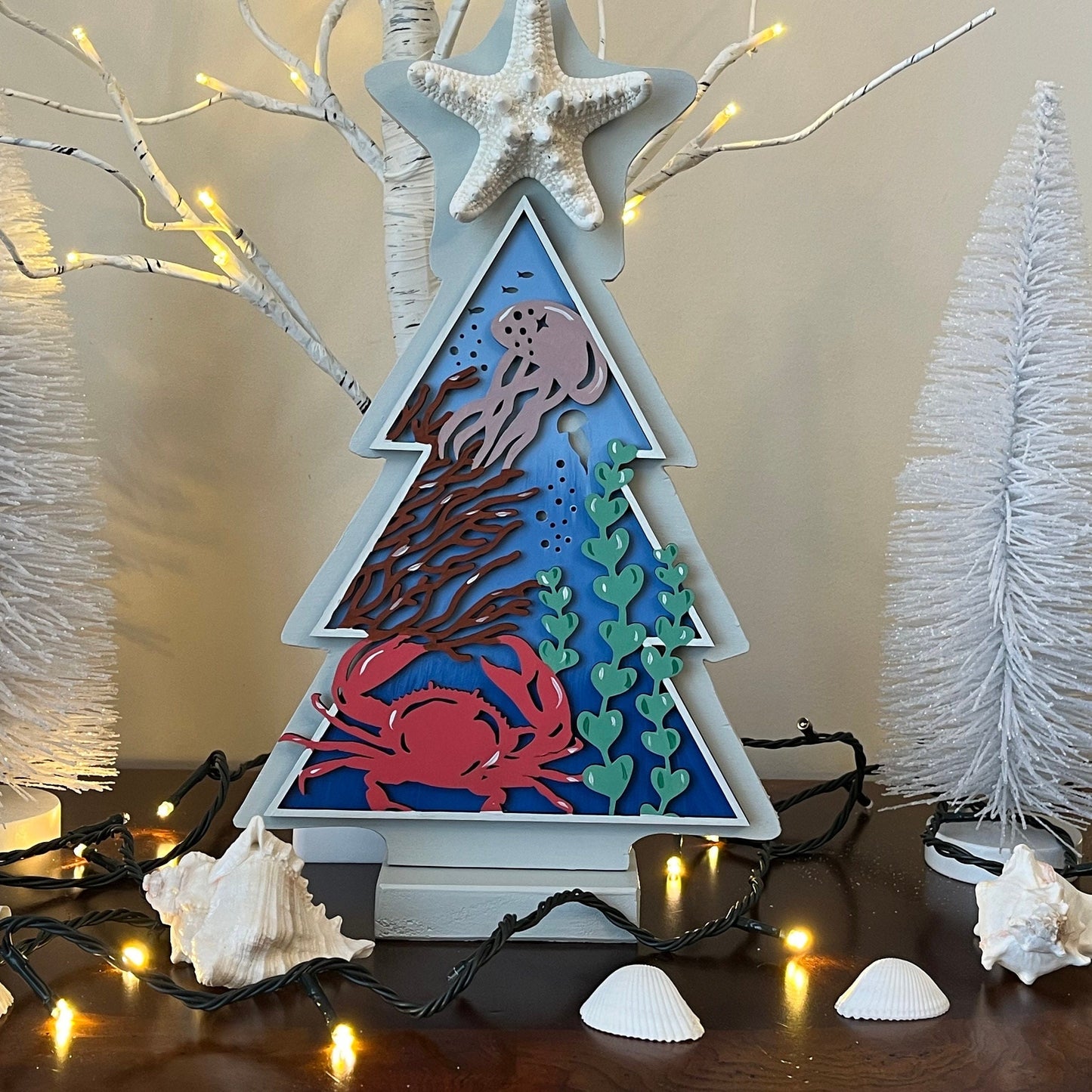 12 inch wooden tree standing table decor with an under the sea hand painted scene in the middle and a genuine starfish on top.